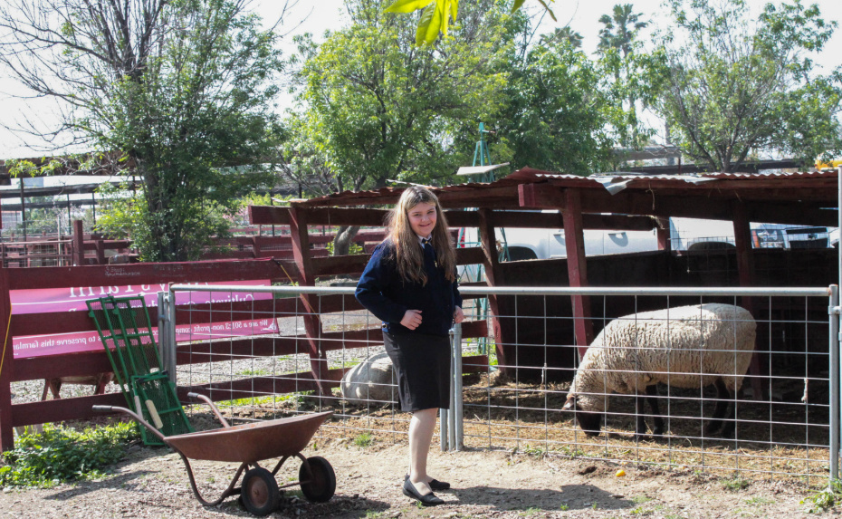 Ms. Natalie Reed, the incumbent President, amidst the distinct sights and smells of a farm.